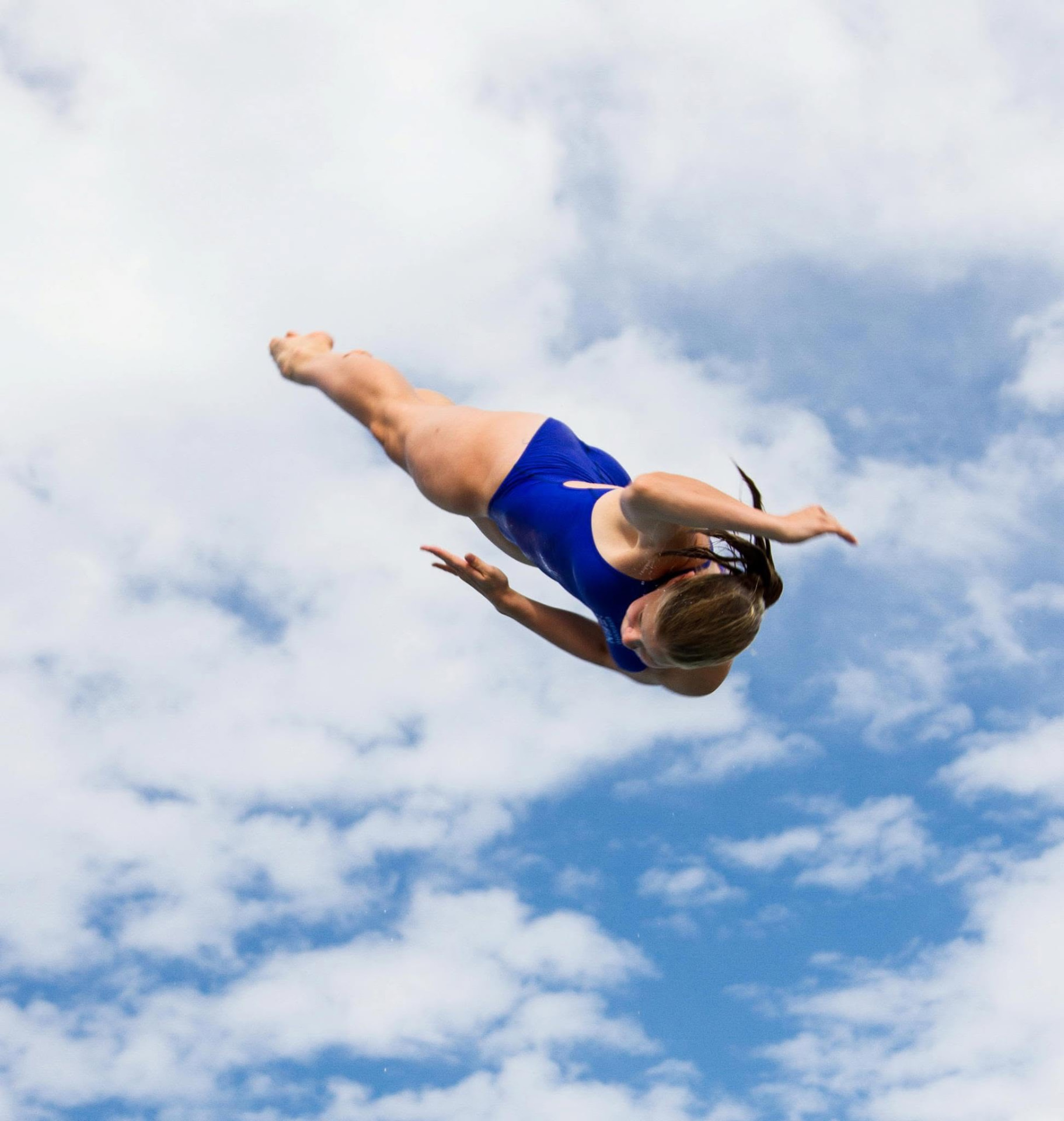 A Silakat diver turning high against a blue summer sky